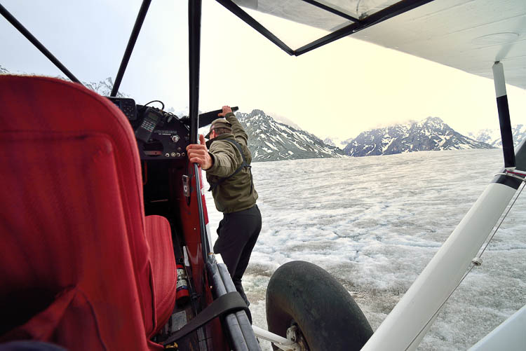 Loni starting the Super Cub after landing on the glacier.