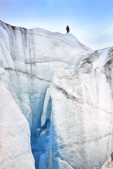 Loni Habersetzer peaking into the cravices of the glacier. 